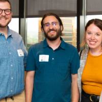 3 people pose for picture at event